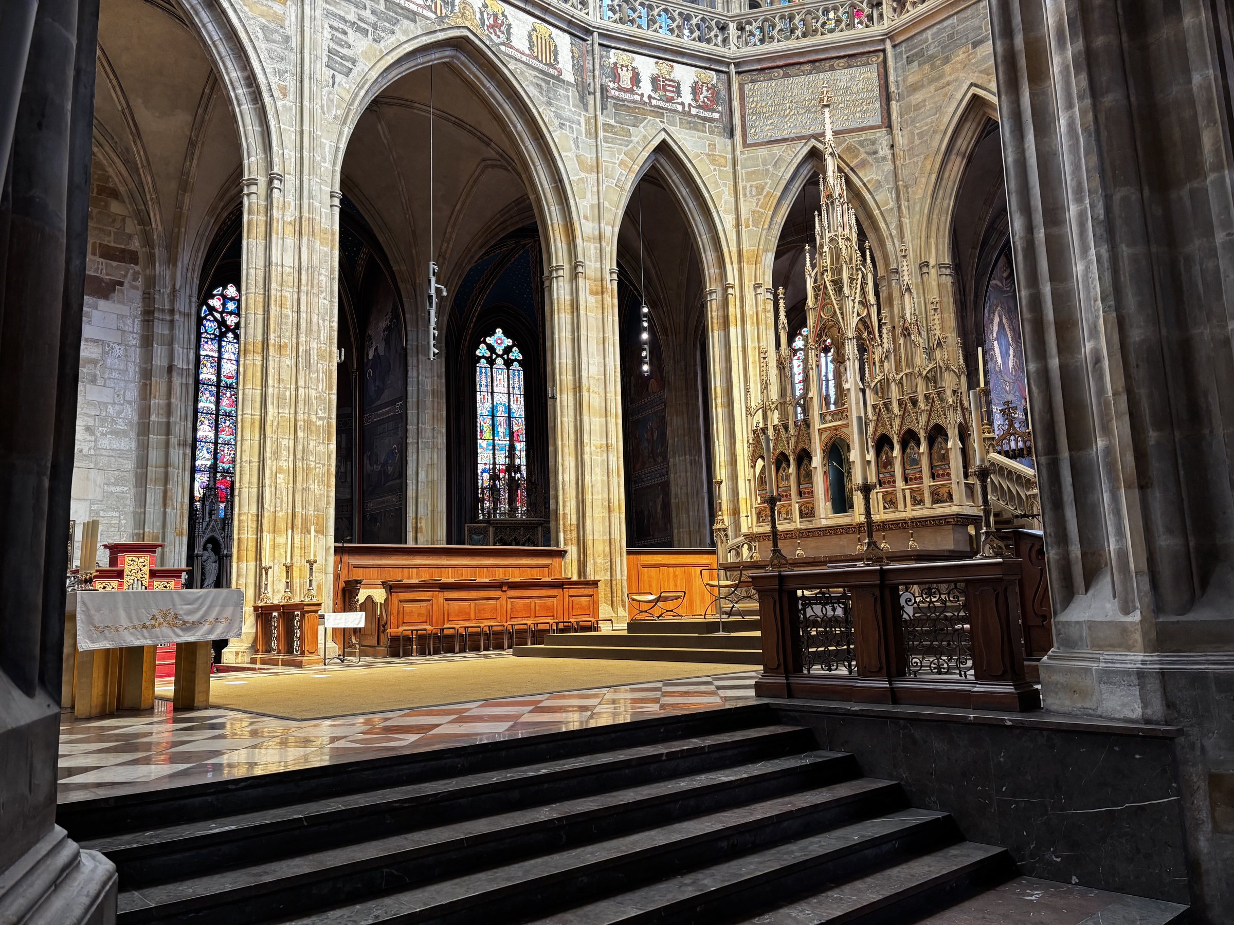 Light as the divine. Ogival arches, clustered piers, and ribbed vaults direct the eye upward towards God and also to the shields of Bohemia and the territories tied to it. Just in case folks needed reminding of who ruled what.