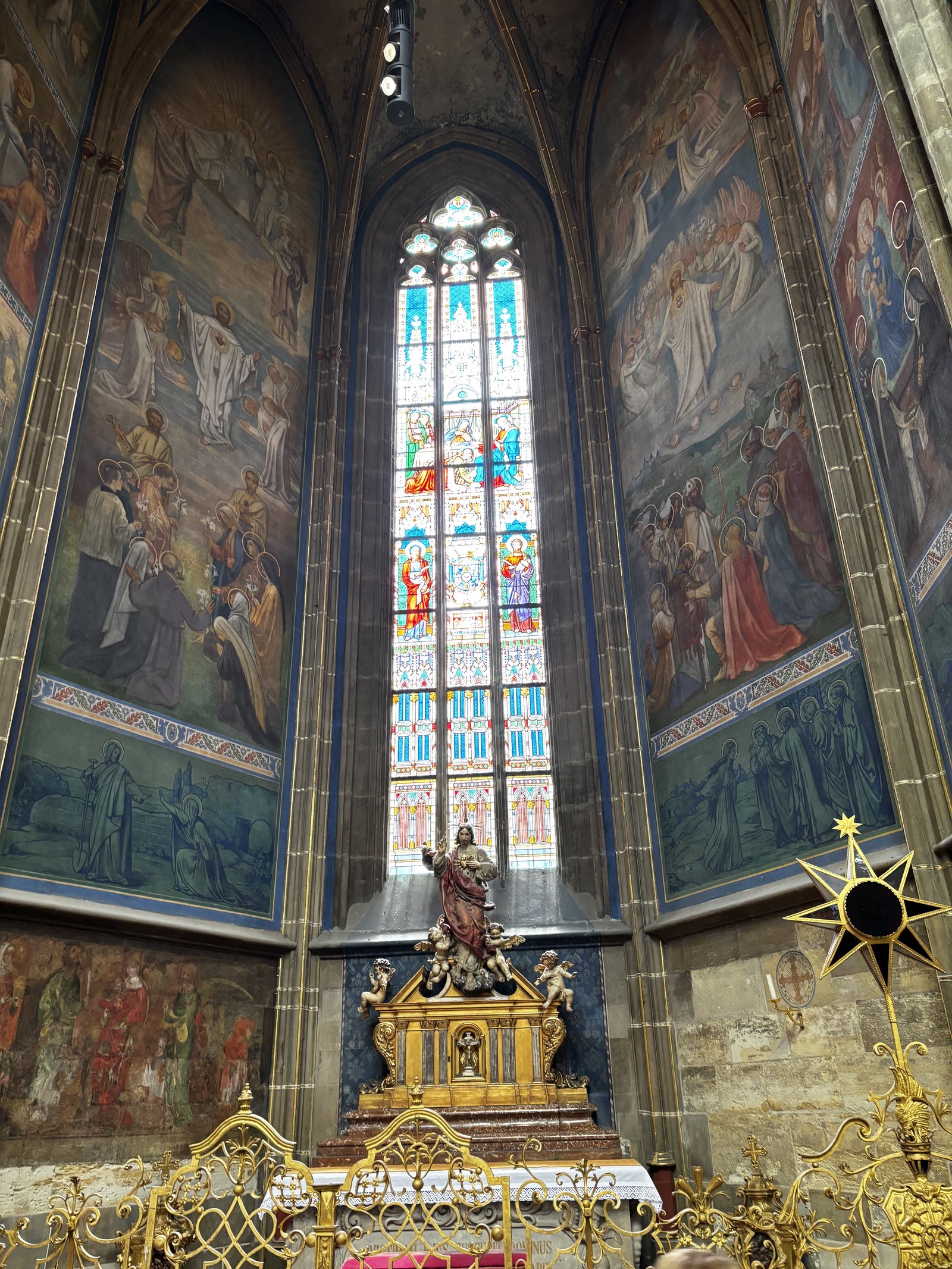 A side chapel in the style of the Nazarene movement. Depictions of the life of a saint.