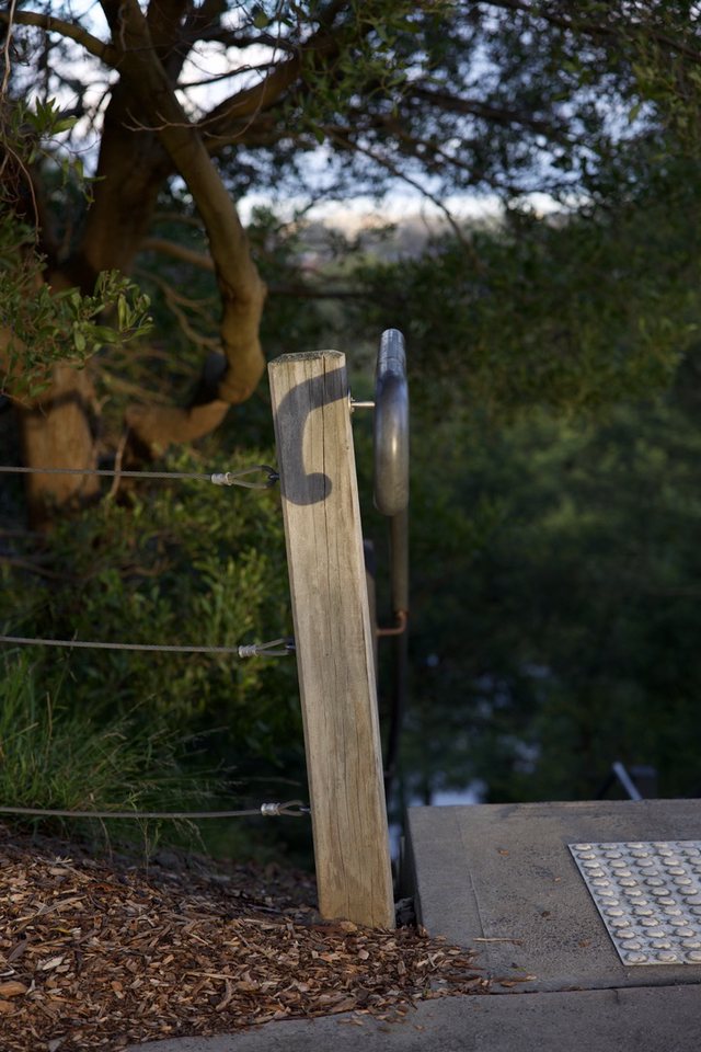 Handrail. The sun had crested a band of cloud creating a shadow of the handrail.